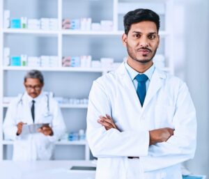 Pharmacist standing confidently in modern pharmacy with colleague