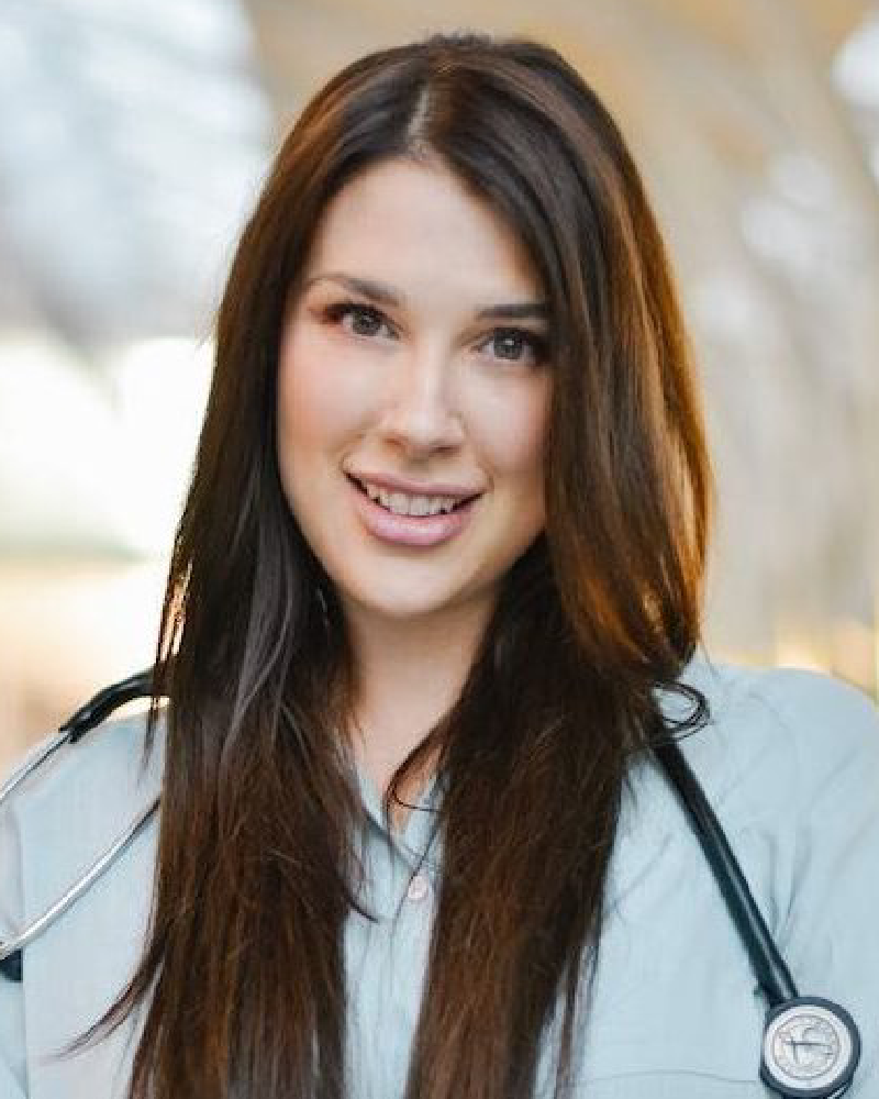 Smiling female doctor with stethoscope outdoors